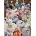 Twenty three C19th and later continental hand painted pin cushion dolls and others mounted on