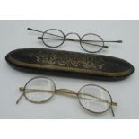 Pair of early C19th white metal spectacles, similar period papier mache spectacles case, pair of