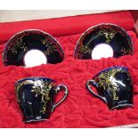 Pair of C20th Royal Dux, Bohemia, cabinet cups and saucers, in fitted case, midnight blue ground