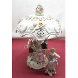 C20th Dresden style table lamp, encrusted with flowers with pierced shade, with children dancing