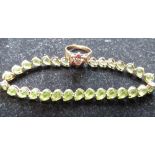 10ct yellow gold mounted articulated bracelet with tear drop green stones, with a box clasp