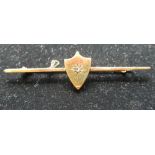 9ct yellow gold bar brooch, central shield inset with a round cut diamond, stamped 9ct, L6.5g, gross
