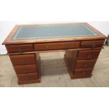 C20th PINE kneehole twin pedestal desk, with gilt tooled inset top, three frieze and six pedestal