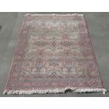 C20th Jacquard traditional pattern wool rug, pink ground with central floral pattern reserve, with