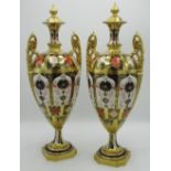 Pair of Royal Crown Derby 1128 pattern porcelain two handled pedestal vases, ovoid bodies with