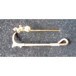 Hallmarked 9ct yellow gold riding crop brooch, approx 5cm, 3.7g and a yellow metal pin stick with