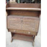 Late Victorian Gothic revival oak escritoire, carved fall front and single drawer with lion mask