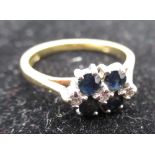 Hallmarked 18ct yellow gold diamond and sapphire ring, four claw set round cut sapphires and three