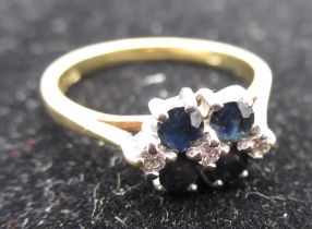 Hallmarked 18ct yellow gold diamond and sapphire ring, four claw set round cut sapphires and three