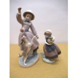 Lladro figure of a girl playing with a dog, blue potters mark to the base, no.B-4J, H27.5cm (A/F),