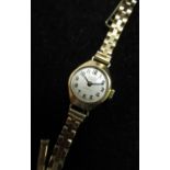 Ladies Avia gold hand wound wristwatch, signed brushed silvered dial with applied Arabic numerals,