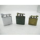 Two early Dunhill brass Unique Lighters and a Dunhill double wheel lighter(3)