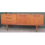 Mid-century Nathan teak sideboard with three drawers, a fall front and a cupboard on square