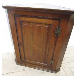 Geo. III oak corner cabinet, with moulded cornice above mahogany cross banded panel door inlaid with