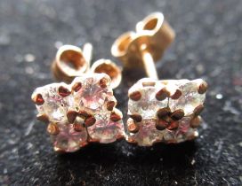 Pair of diamond earring studs, four round cut diamonds claw set on yellow metal mounts, gross 0.9g