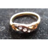 18ct yellow gold diamond ring, three graduating round cut diamonds inset in a white metal mount with