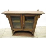 Arts and crafts wall cabinet, with two glazed doors above arched recess, W77cm D16cm H68cm