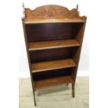 Early C20th oak four tier folding bookcase with shell carved frieze on shaped supports, W65cm