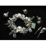 Sterling silver charm bracelet with heart padlock clasp with a variety of silver and white metal