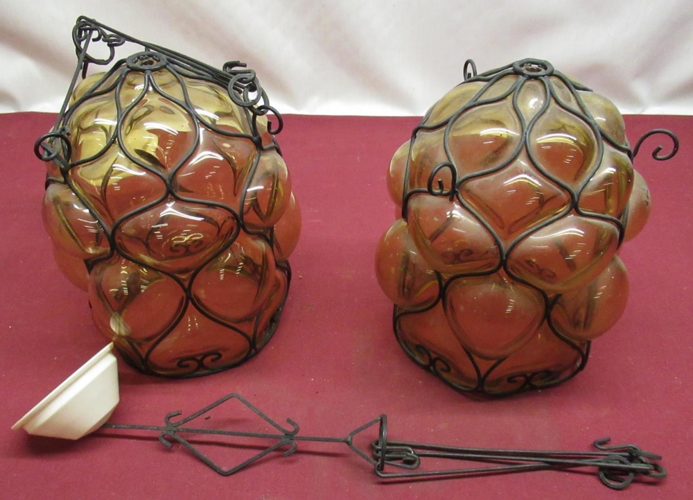 Pair of contemporary bubble glass amber tinted hanging lamp shades with wire work skeletal molding