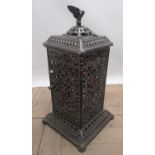 Small French cast iron heater, body with hinged door and removable cover with eagle finial, H64cm
