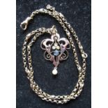 9ct yellow gold openwork pendant set with seed pearls and a claw set blue stone on a 9ct yellow gold