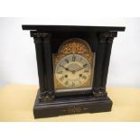 Late C19th continental mantel clock, ebonised style case on rectangular stepped base brake arch dial