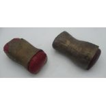 Two brass art instillations one with red leather cushion, the other in dark red leather, made by