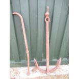 An antique cast iron ships anchor