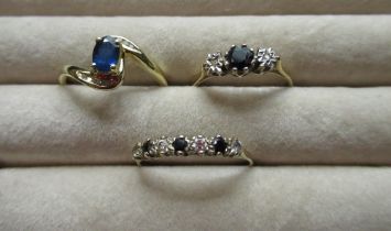 Hallmarked 9ct yellow gold diamond and sapphire ring, round cut claw set sapphire flanked by two