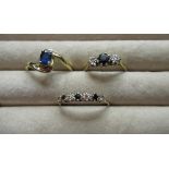 Hallmarked 9ct yellow gold diamond and sapphire ring, round cut claw set sapphire flanked by two