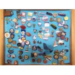 Mahogany table top display cabinet containing a collection of lapel badges including YMCA, Butlins