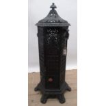 French cast iron heater, hexagonal body with colour panels, hinged door and brass burner, the