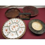 C20th lazy Susan of circular form with seven fitted ceramic dishes makers mark to the base, mahogany