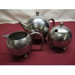 1960's stainless steel spherical three piece tea set comprising teapot, milk jug and sugar bowl,