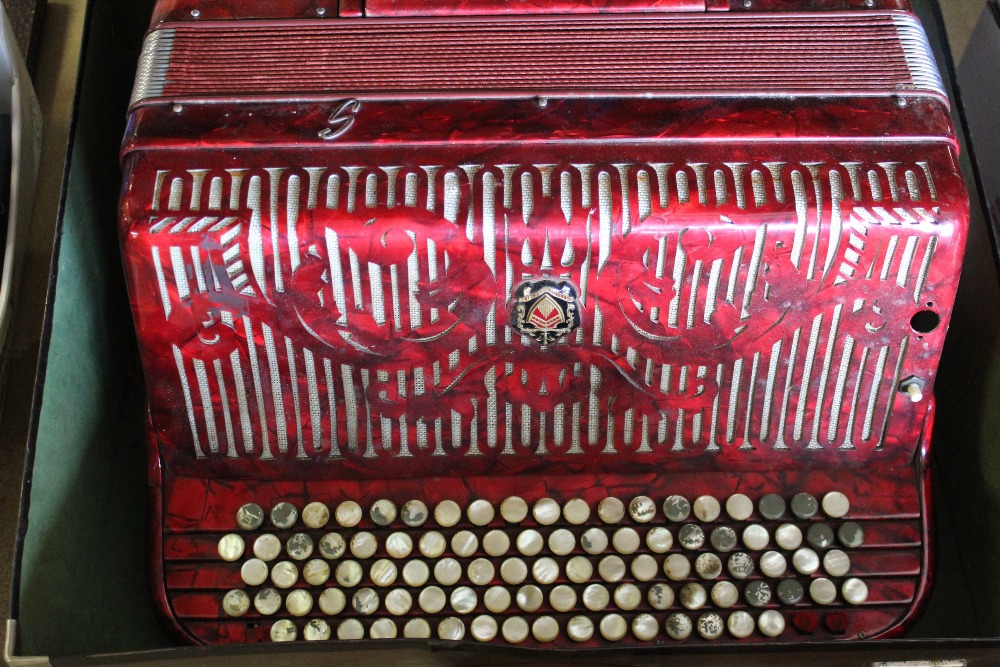 C20th Ca Scandalli Italia, piano accordian, in marbleised red case with mother of pearl button