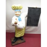 Resin figure of a chef holding a chalkboard, H73cm