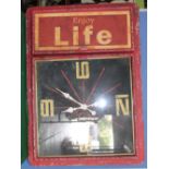 Large red enamel wall clock scripted to side cupboard 'Enjoy Life', W100cm, H70cm