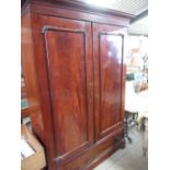 Victorian mahogany two door wardrobe, moulded cornice and drawer base with wooden ring handles, on
