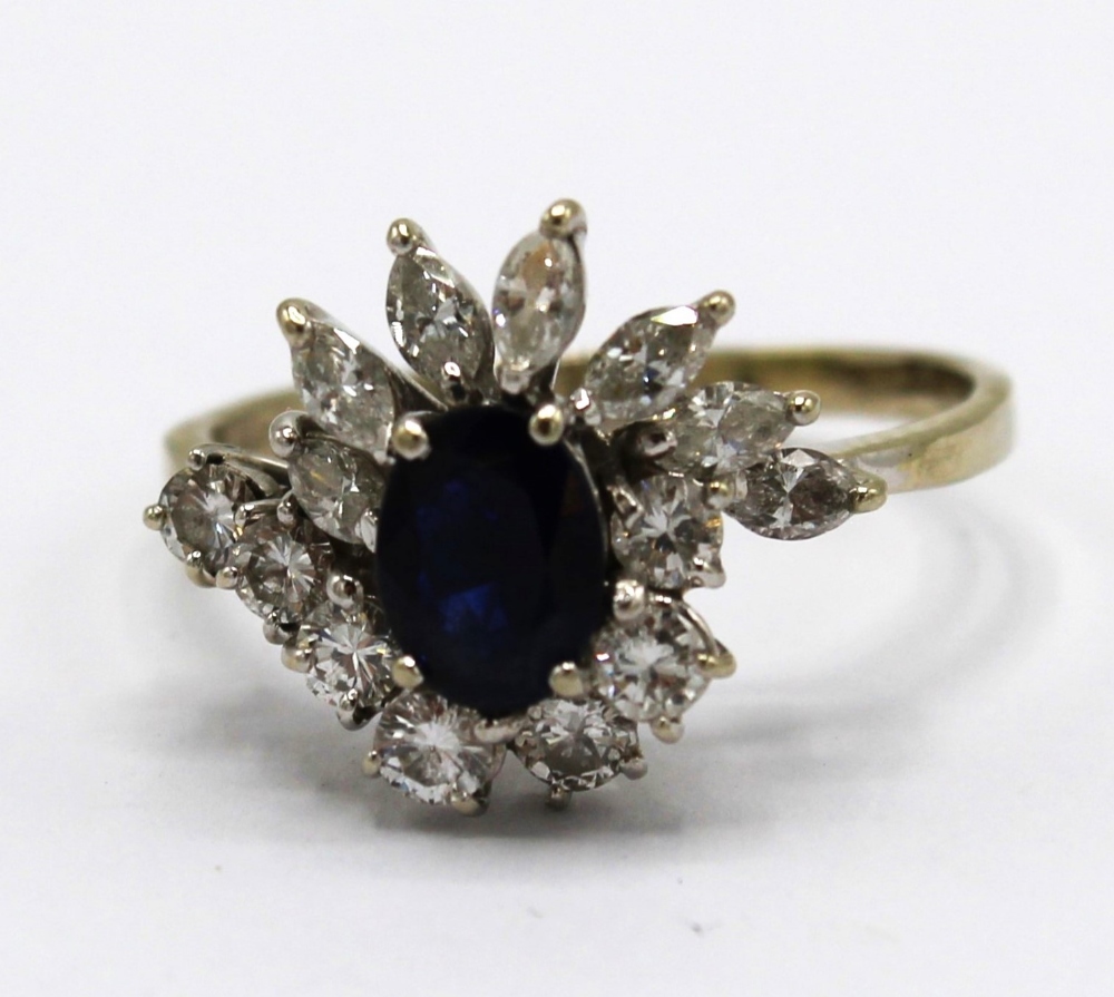 18ct white gold sapphire and diamond cluster ring, the central oval cut sapphire surrounded by seven