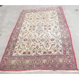 Persian style carpet, ivory ground with floral motifs within decorative border, 220cm x 150cm