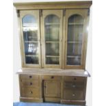 Large Victorian and later pine bookcase, moulded cornice above four glazed doors with three