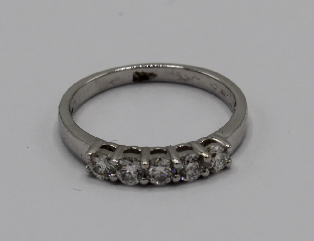 18ct white gold ring, set with five brilliant cut diamonds, stamped 750, size N, 3.2g