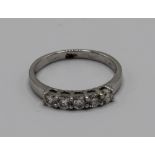 18ct white gold ring, set with five brilliant cut diamonds, stamped 750, size N, 3.2g