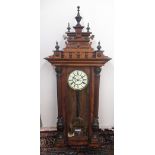 Victorian walnut cased Vienna type wall clock, pediment with urn finials, circular Roman dial with