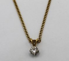 18ct solitaire round cut diamond pendant on 18ct yellow gold chain, both stamped 750, L26cm, 7.3g