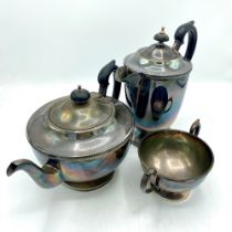 ERII hallmarked Sterling silver three piece tea service, teapot with ribbed rim, ebonised handle and
