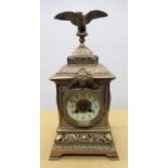 C20th brass cased mantel clock, square case with eagle finial, circular Roman dial on pierced