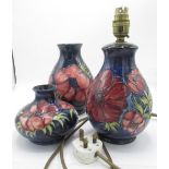 Moorcroft Poppy pattern baluster table lamp and two similar vases, signed on base, (3)