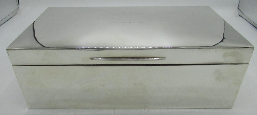Large Geo.V hallmarked silver cedar lined rectangular table cigarette box, lid engraved 'Presented